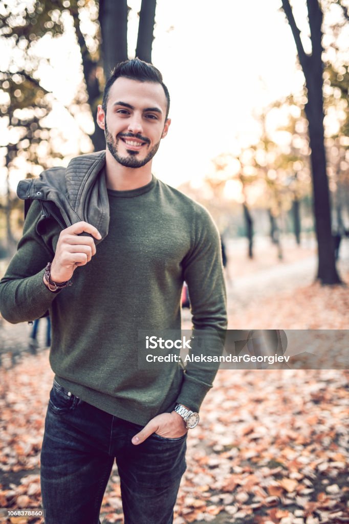 Handsome Male Model Posing In Park On Autumn Morning